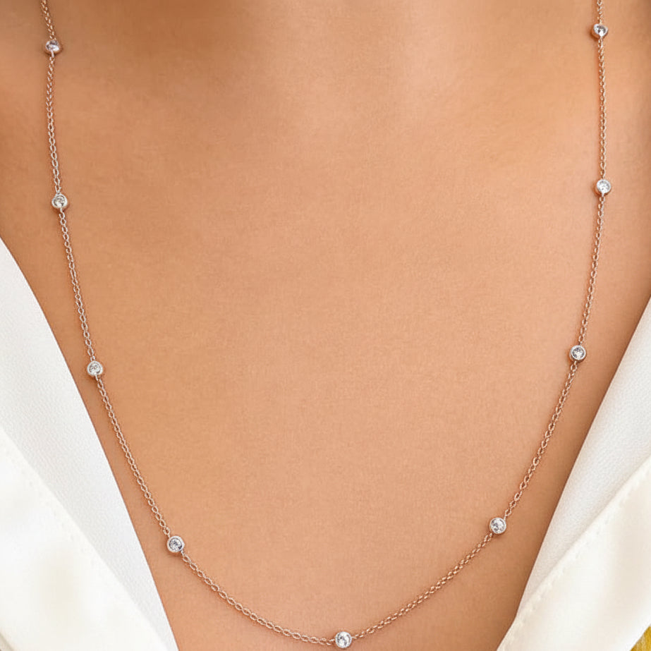 18k rose gold necklace with evenly spaced bezel‑set diamonds on a 24‑inch chain