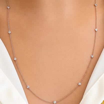 18k rose gold necklace with evenly spaced bezel‑set diamonds on a 24‑inch chain