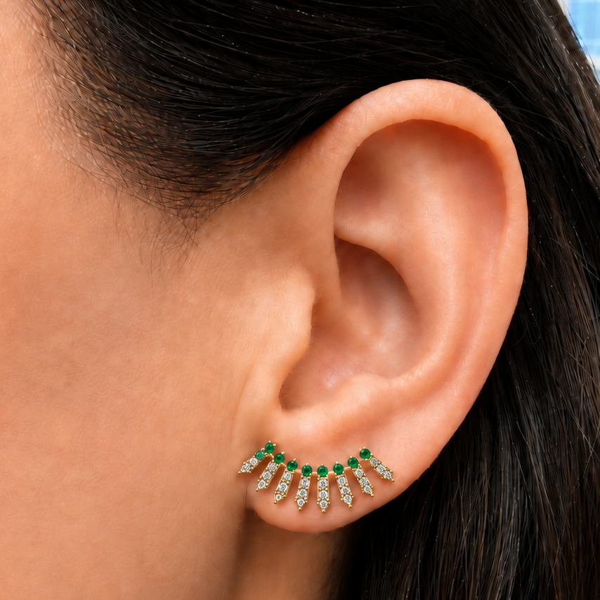 14k yellow gold ear crawlers with 46 diamonds and 18 round emeralds, angled view
