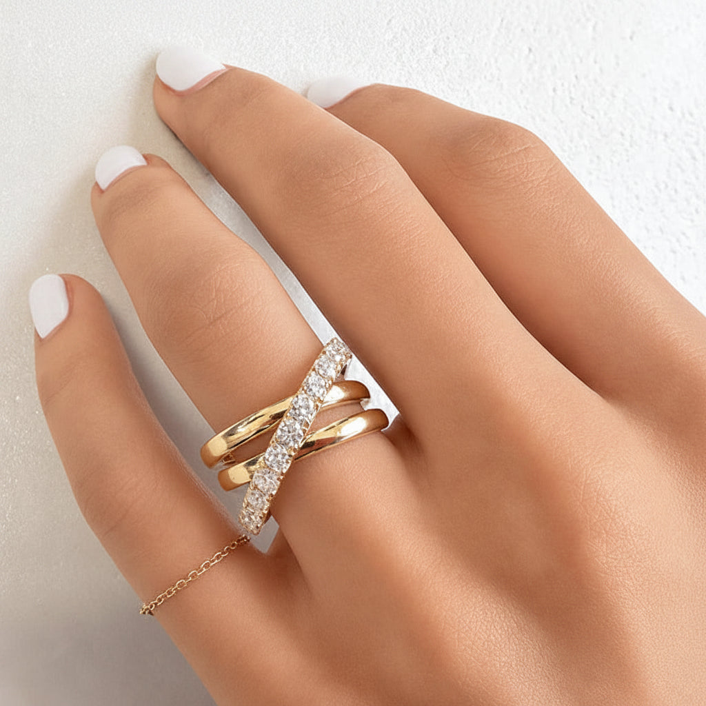 18k yellow gold crossover ring with pave diamonds along intersecting bands