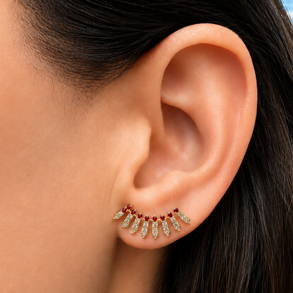 14k yellow gold ear crawlers with 46 diamonds and 18 round rubies, angled view