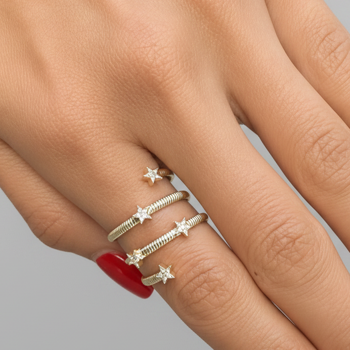 18k yellow gold spiral ring with diamond star details by Diamond Tales