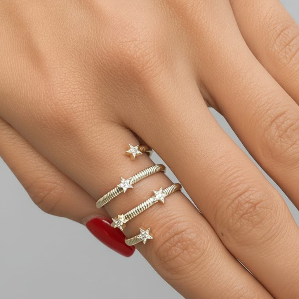 18k yellow gold spiral ring with diamond star details by Diamond Tales