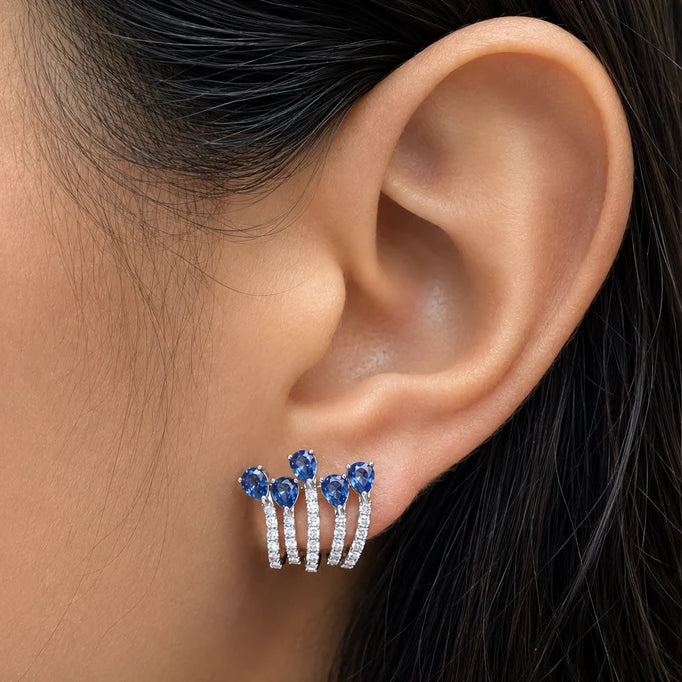 18k white gold lobe studs with five pear blue sapphires and diamonds per ear