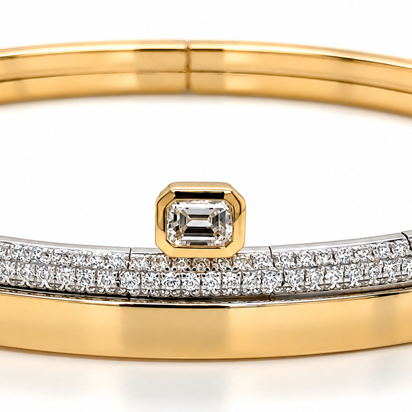 Detail of the central emerald-cut diamond set among round pave diamonds