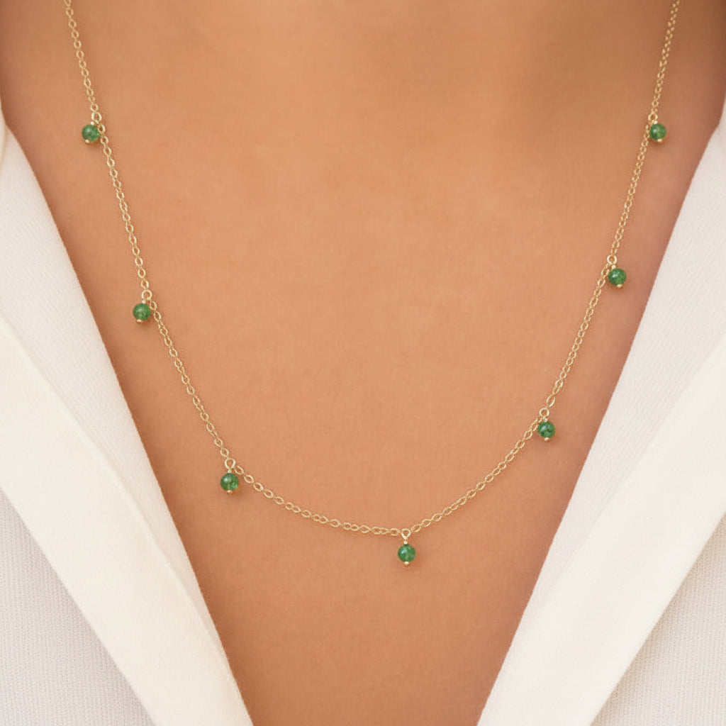 emerald shaker pendant necklace in 14k gold with moving round emeralds