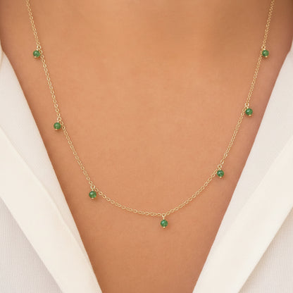 emerald shaker pendant necklace in 14k gold with moving round emeralds