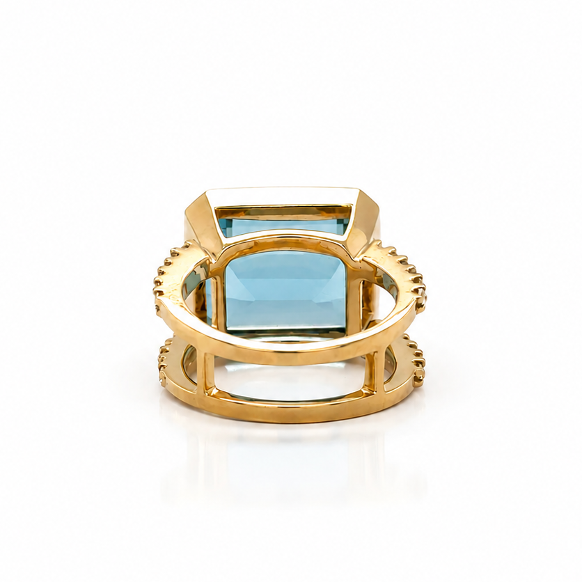 Aquamarine cocktail ring in 18k yellow gold shown on the hand, size 6