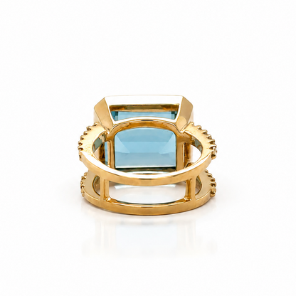 Aquamarine cocktail ring in 18k yellow gold shown on the hand, size 6