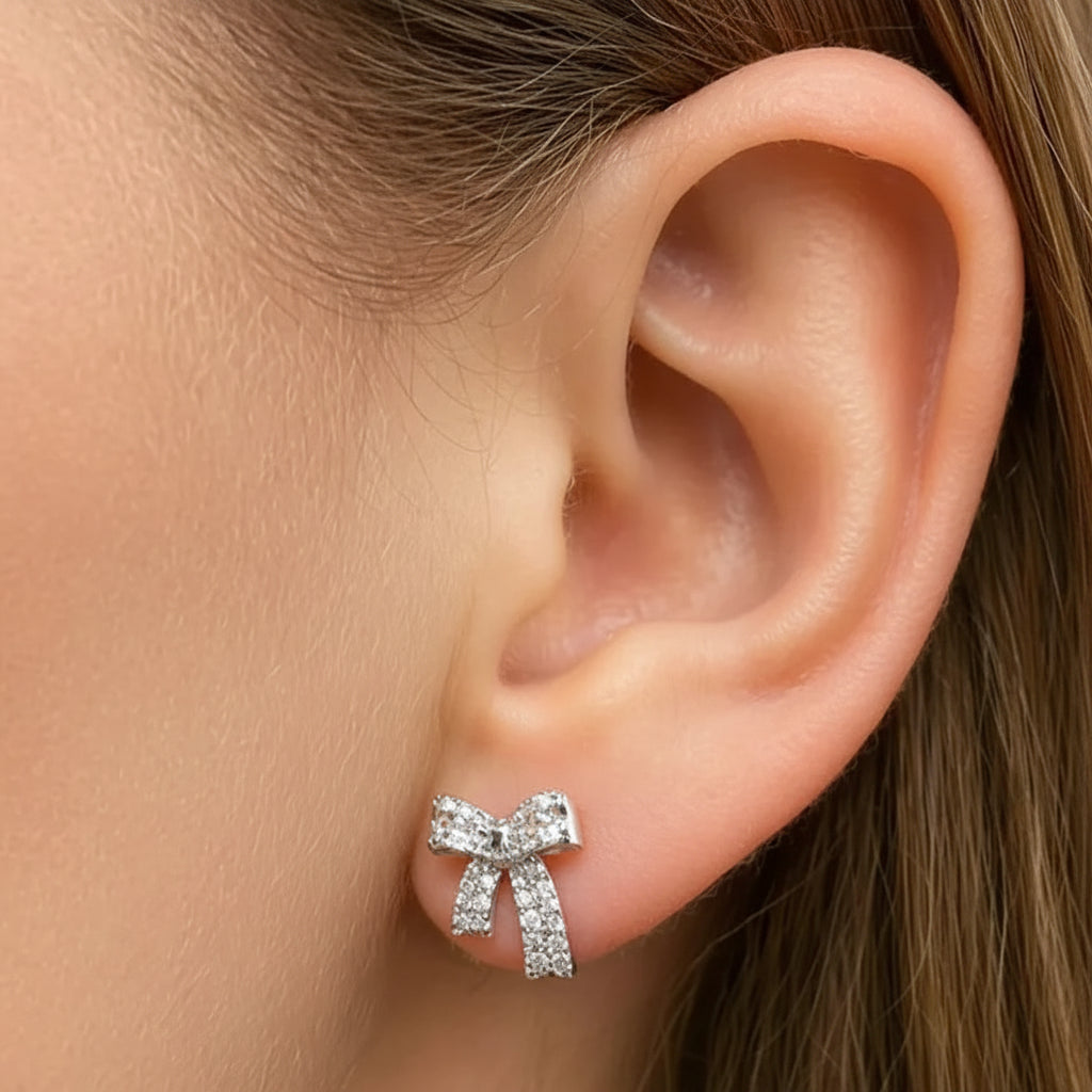 18k white gold bow stud earrings with diamond accents totaling 0.34 cts