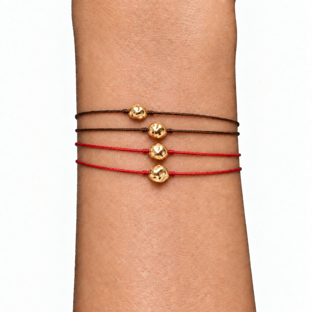 Gold nugget macramé cord bracelets stacked on the wrist