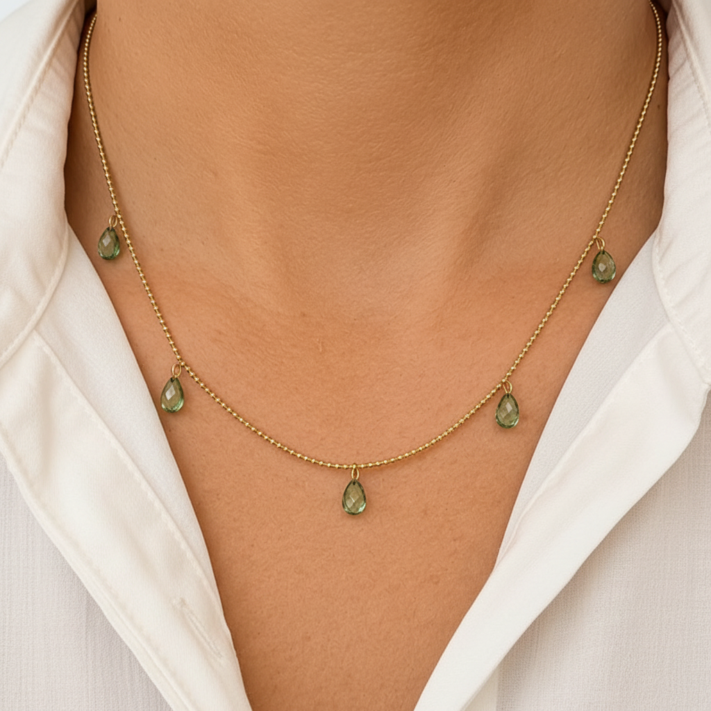 14k gold shaker necklace with five green sapphires