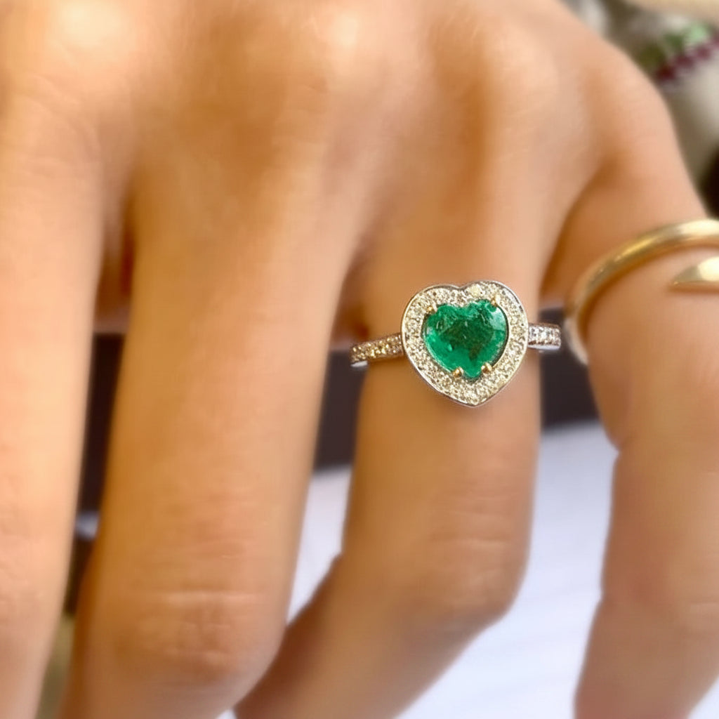 18k gold ring with a heart-shaped emerald surrounded by diamonds