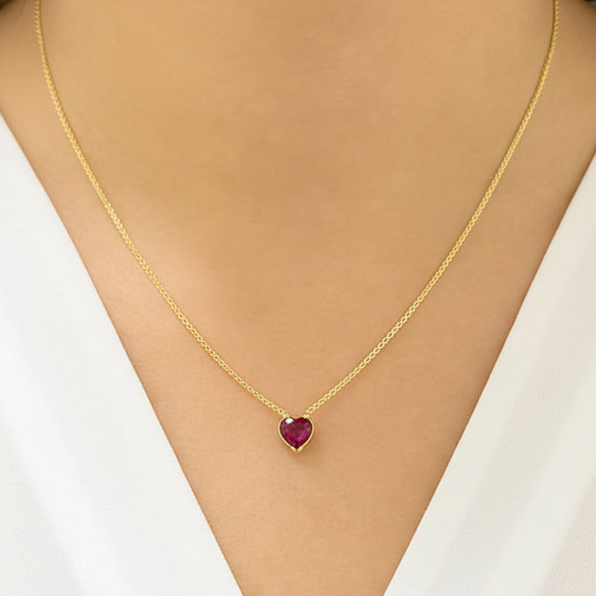 18k yellow gold necklace featuring a heart-shaped ruby cabochon pendant