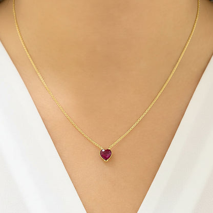 18k yellow gold necklace featuring a heart-shaped ruby cabochon pendant
