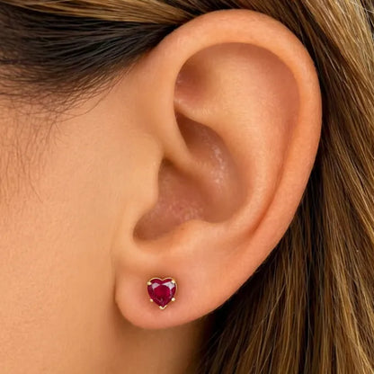 18k yellow gold stud earrings featuring heart-shaped ruby cabochons