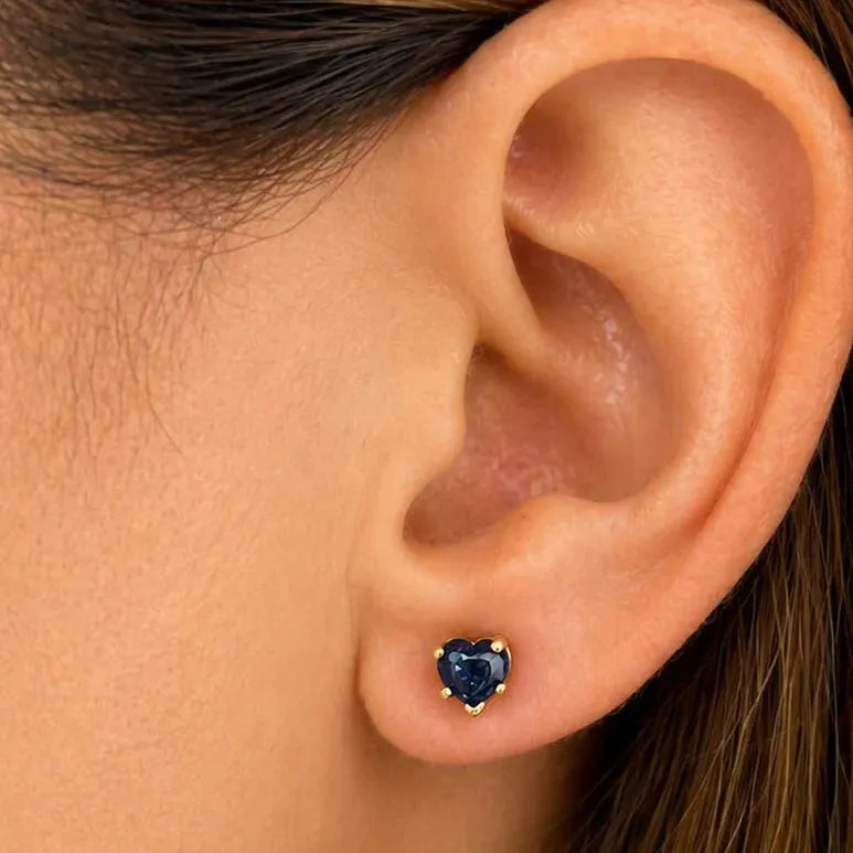 14k yellow gold stud earrings featuring heart-shaped blue sapphire cabochons