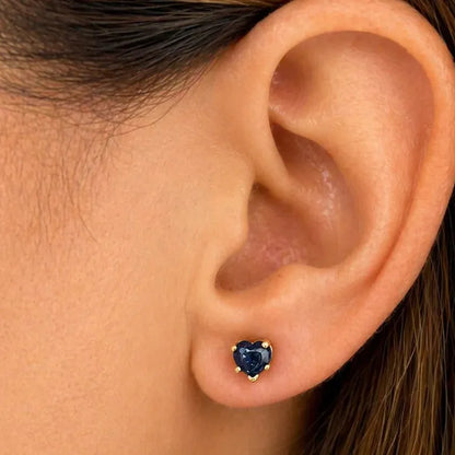 14k yellow gold stud earrings featuring heart-shaped blue sapphire cabochons