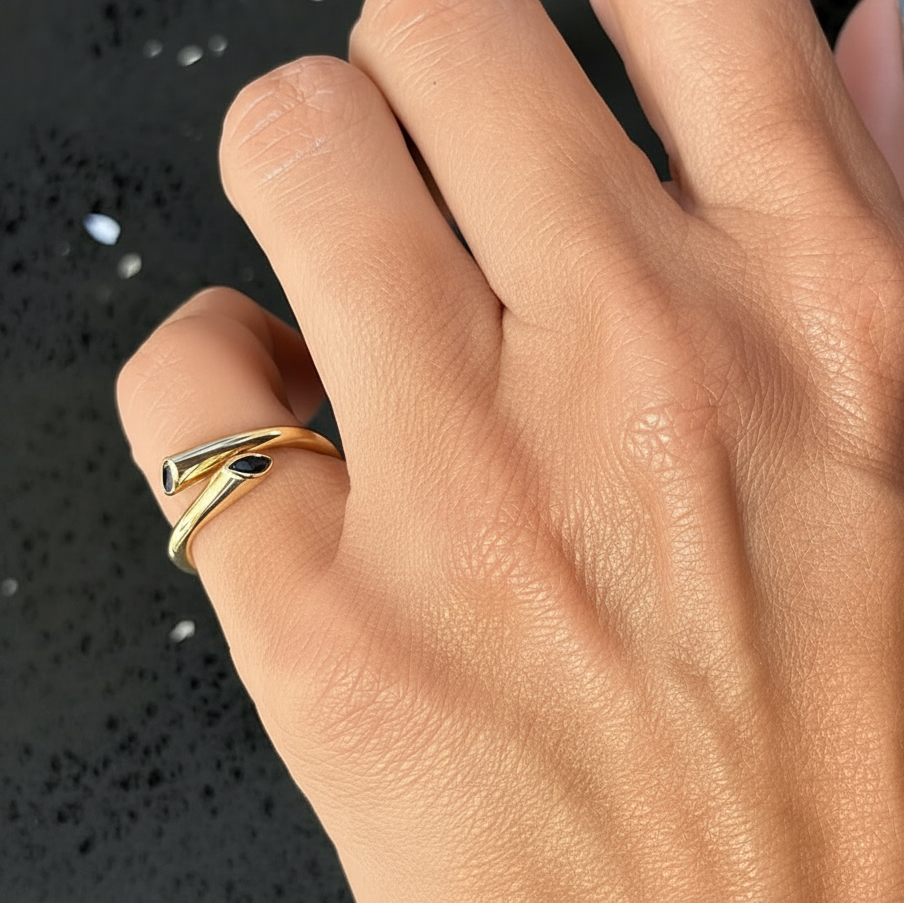 Marquise blue sapphire spring ring shown worn on the hand