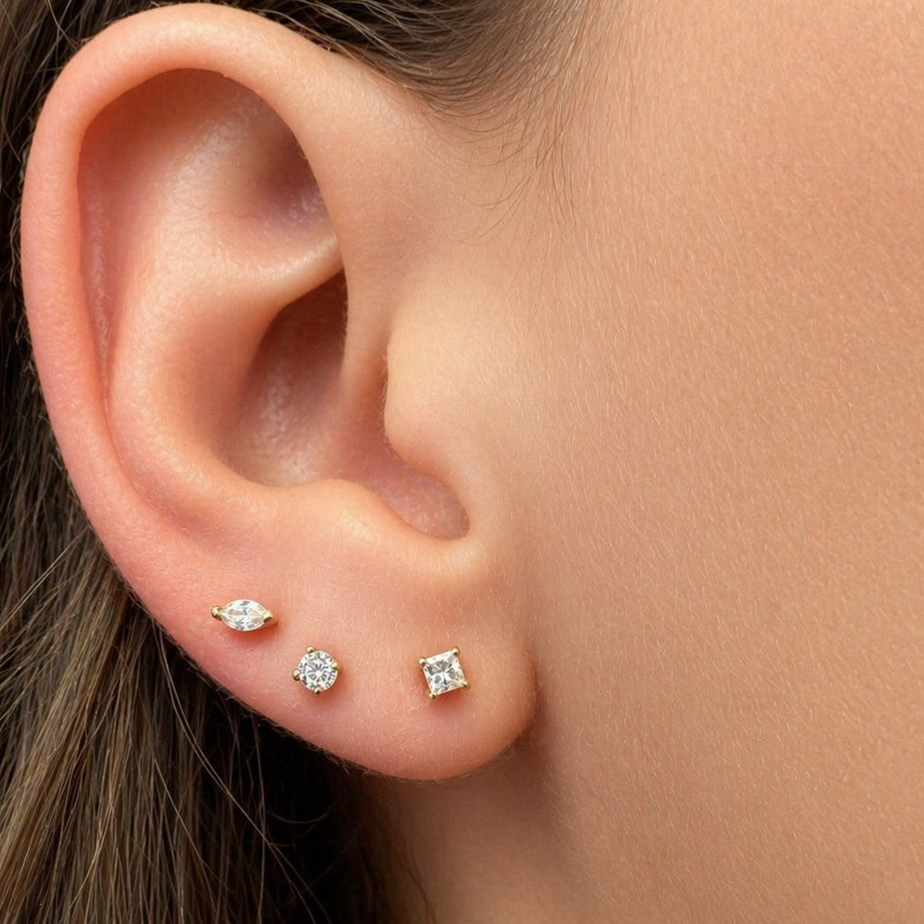 Mini round diamond stud earrings shown at actual scale