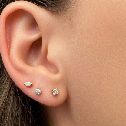 Mini round diamond stud earrings shown at actual scale