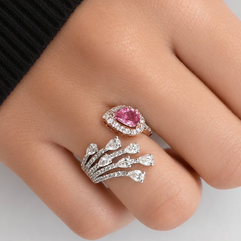 18k white and rose gold open band ring with a pear-shaped blue sapphire and diagonal diamond accent