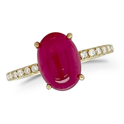 18k yellow gold band featuring an oval ruby cabochon and round diamond accents