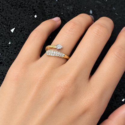 18k yellow gold open wrap diamond ring with pear diamond worn on hand
