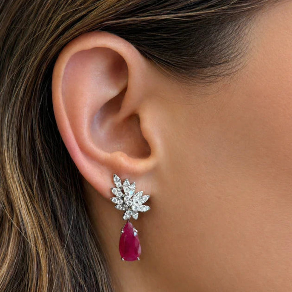 18k white gold drop earrings with pear rubies and brilliant‐cut diamond accents