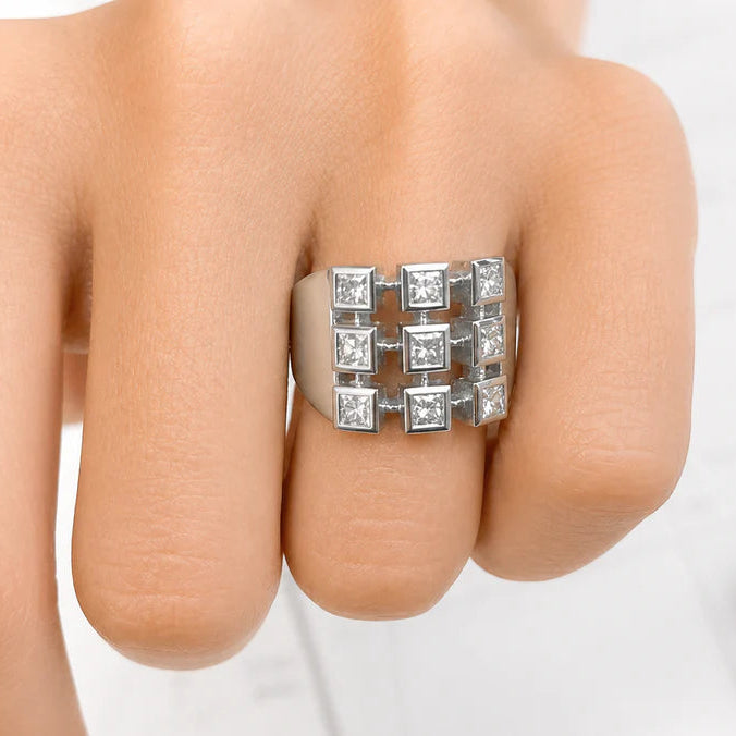 18k white gold ring with nine princess cut diamonds totaling 1.15 cts