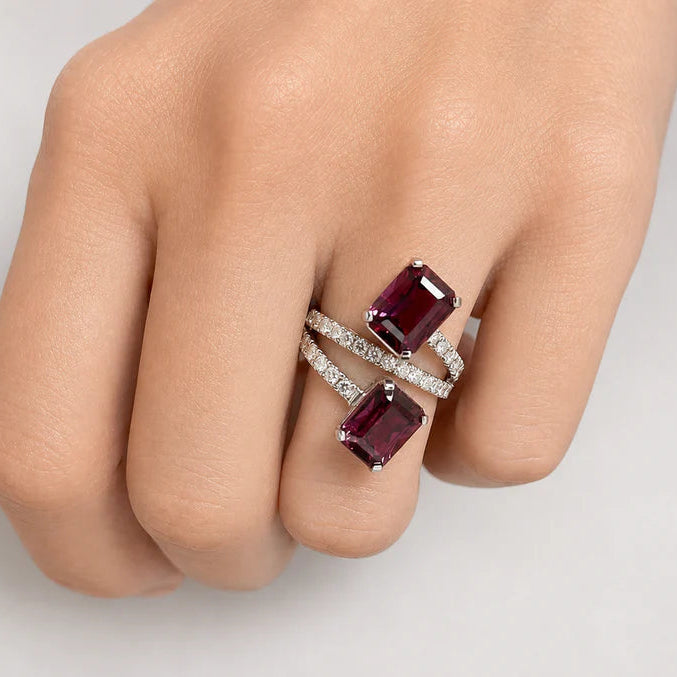 18k gold ring featuring a purple garnet center with pavé diamonds