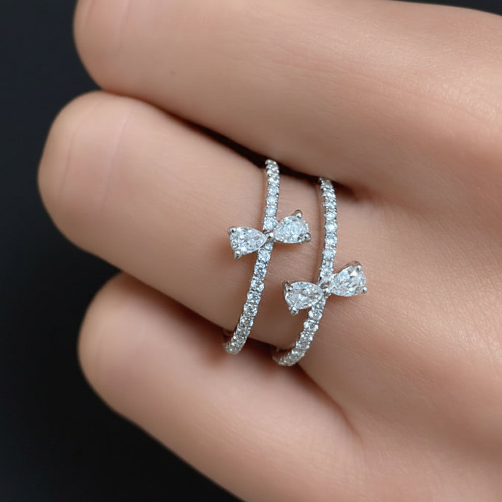 14k white gold ribbon-style ring with pear-shaped and pave diamonds totaling 0.56 cts