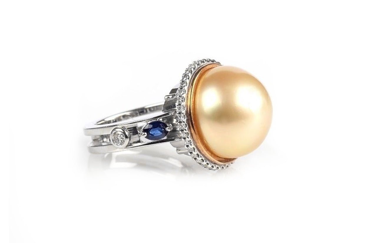 18k gold ring with South Sea golden pearl, pavé diamonds, and blue sapphire accents