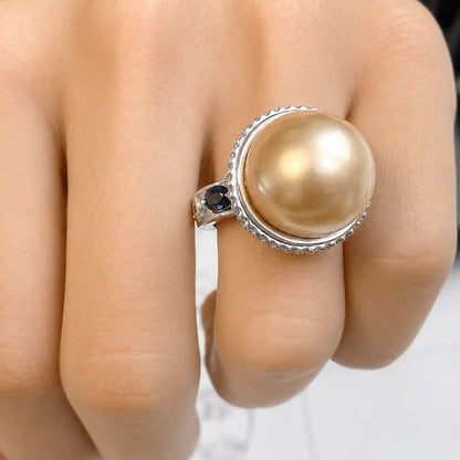 18k gold ring with South Sea golden pearl, pavé diamonds, and blue sapphire accents