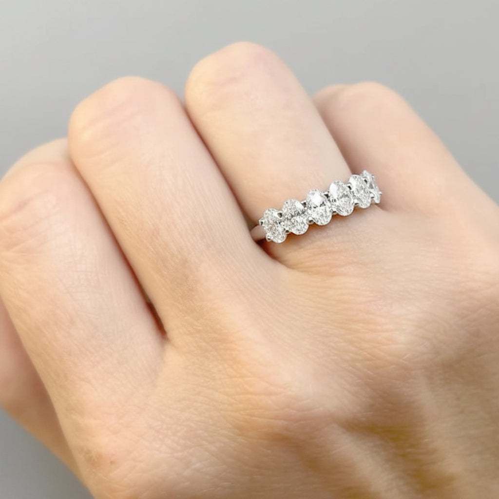 Platinum band featuring six oval-cut diamonds in a clean, linear setting