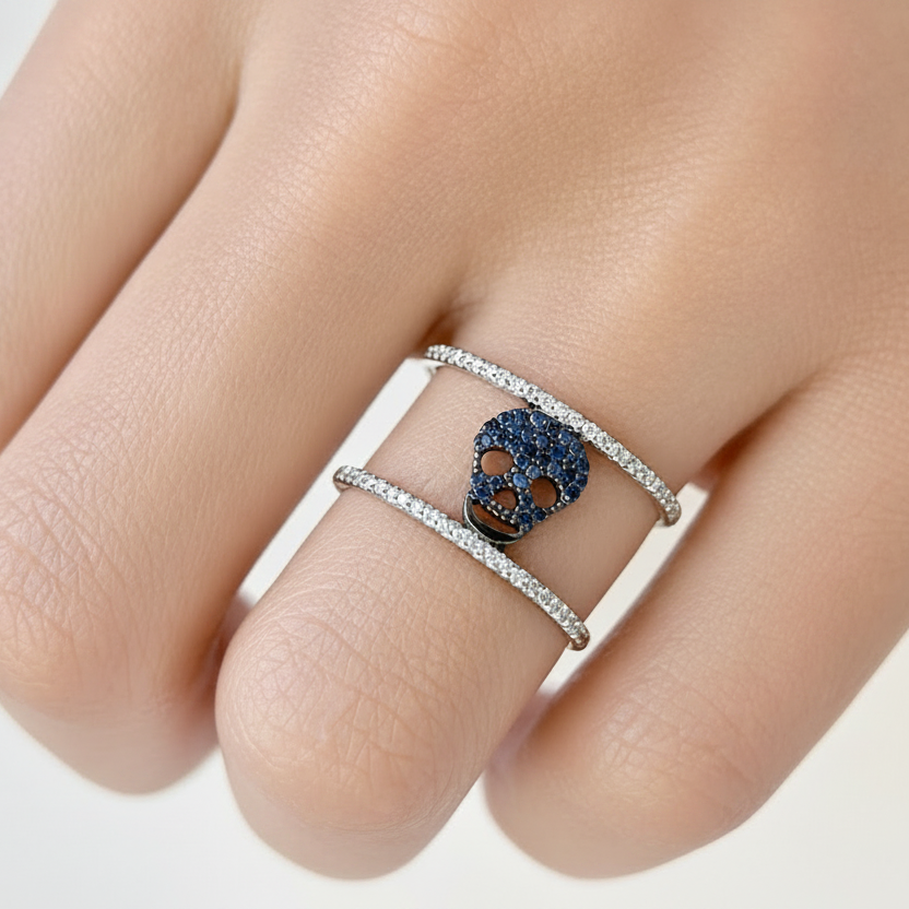 18k gold skull ring with blue sapphires and double row diamonds by Diamond Tales