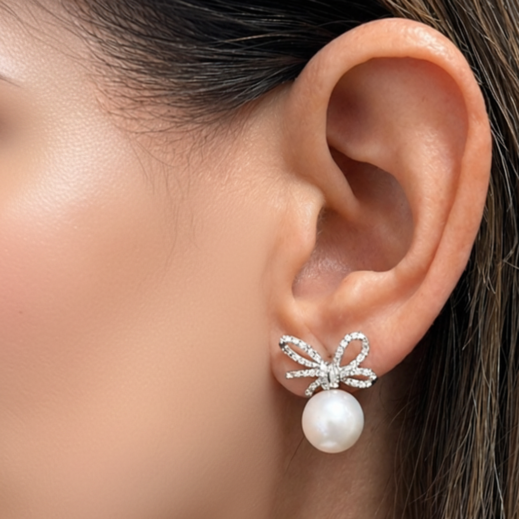 18k gold South Sea pearl and diamond bow earrings by Diamond Tales