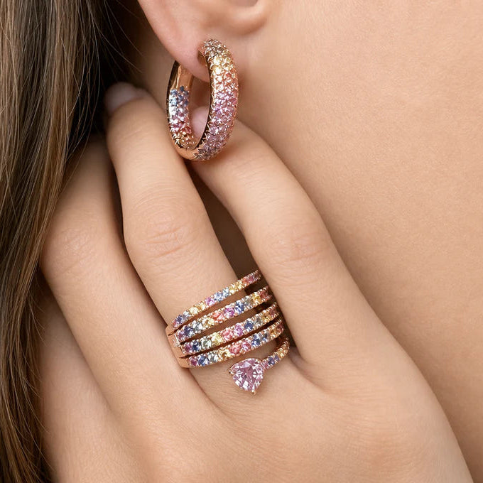 18k rose gold ring with spiral of multicolor sapphires leading to a heart-shaped pink sapphire