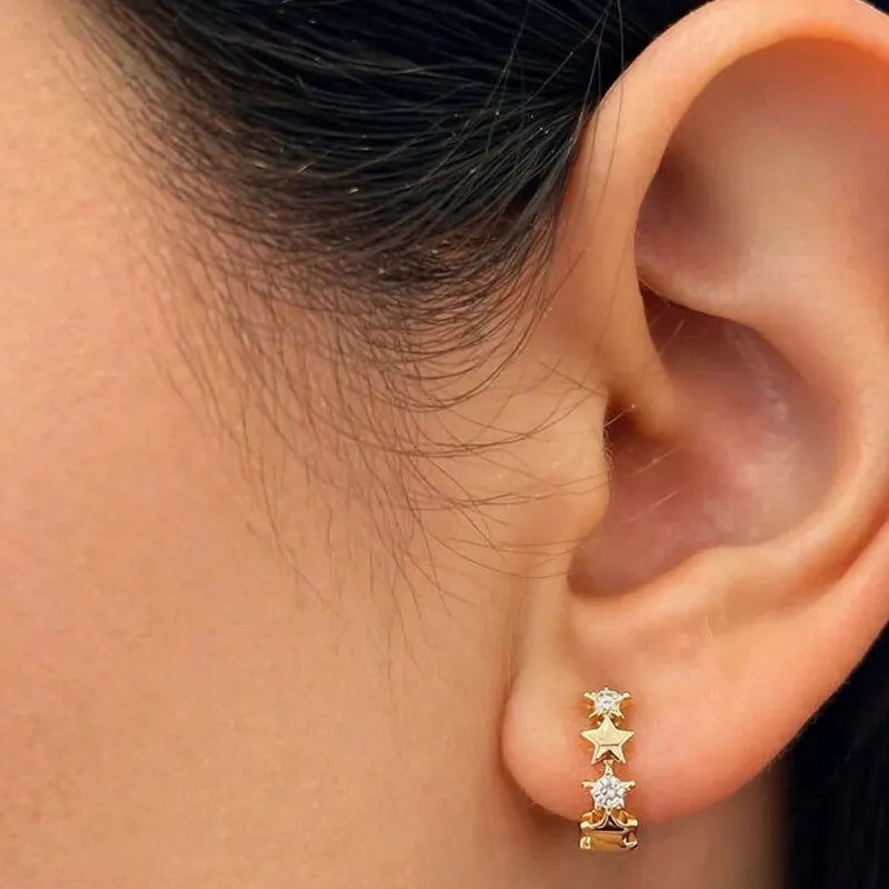 18k gold huggie earrings with hanging star charms and diamond accents