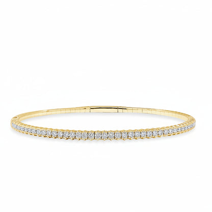 rigid 14k yellow gold tennis bangle bracelet with round diamonds encircling the band