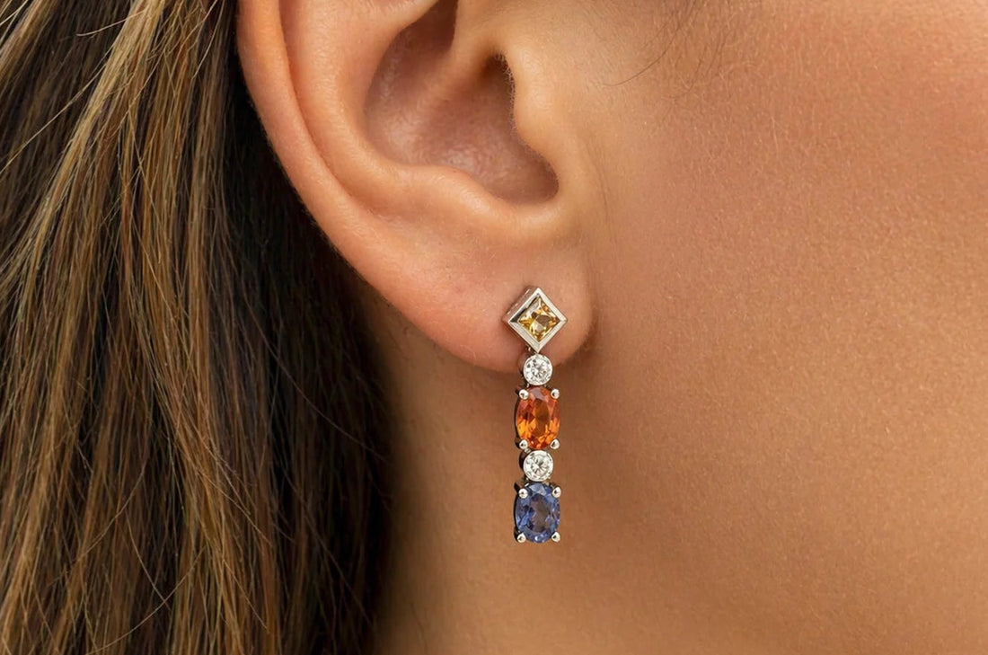 18k gold drop earrings with blue, orange, and yellow sapphire accents and diamonds
