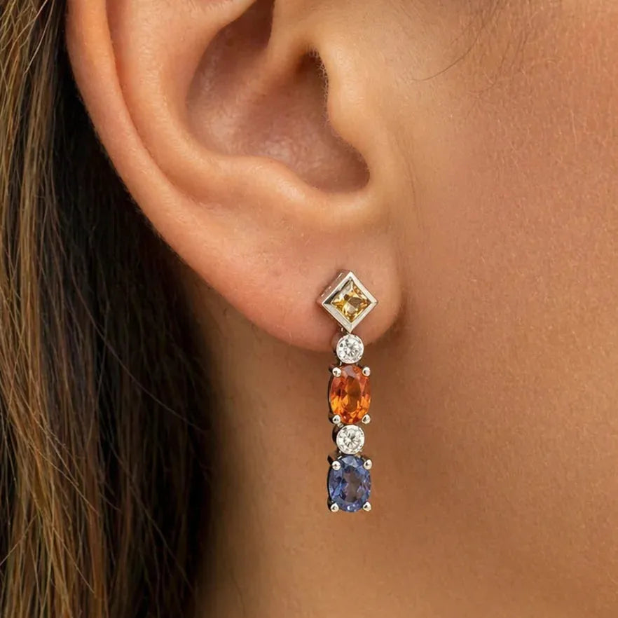 18k gold drop earrings with blue, orange, and yellow sapphire accents and diamonds