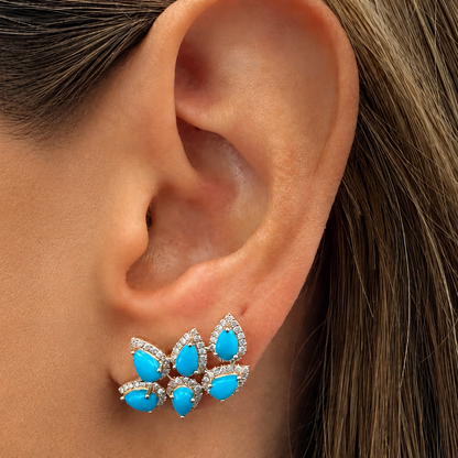 Turquoise and diamond climber earrings shown worn climbing the ear