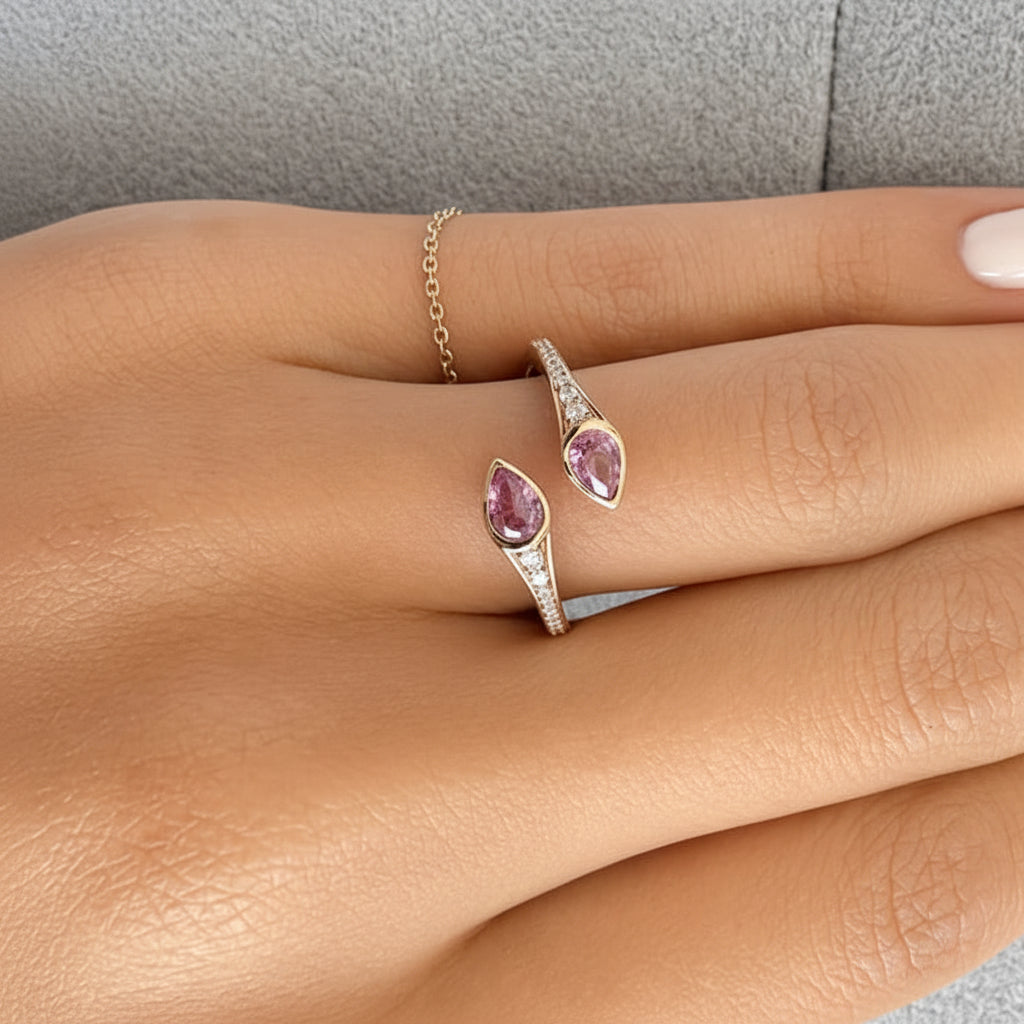 18k gold ring with two pear sapphires and a round diamond accent